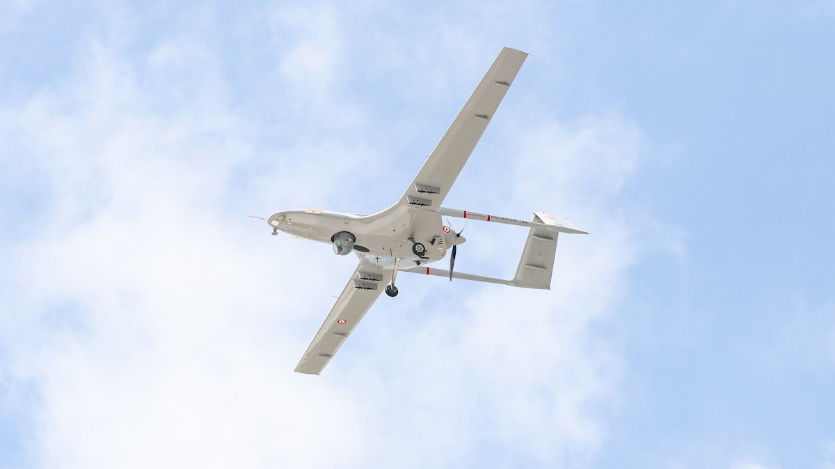Fixed-wing BVLOS drone in flight against a cloudy sky during a long-range survey mission