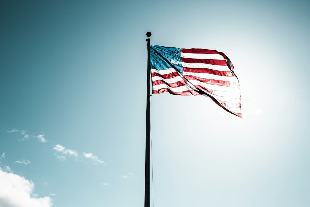 United States flag against a blue sky, representing Blue UAS federal drone procurement rules for government contract work
