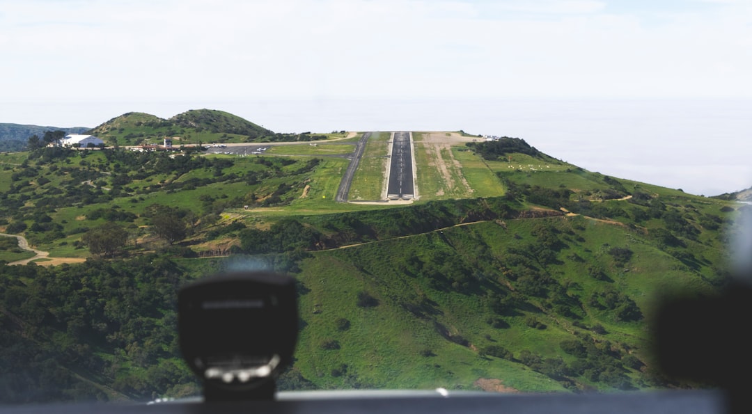 Drone operator preparing a BVLOS flight mission with ground control station and documentation in a rural field