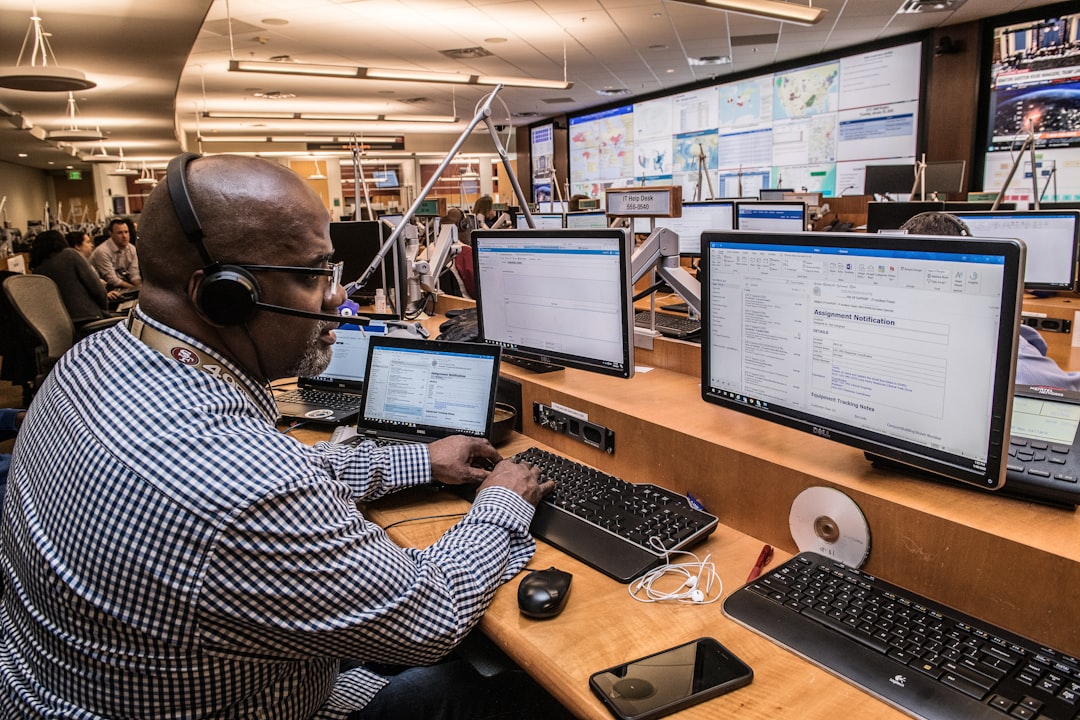 Drone operations manager monitoring an enterprise fleet dashboard on multiple screens, similar to the DJI FlightHub cloud platform
