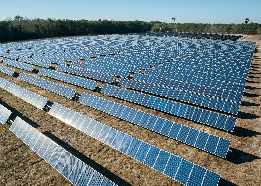 Aerial view of rows of ground-mounted solar panels, a typical DJI Matrice 4T thermal inspection site
