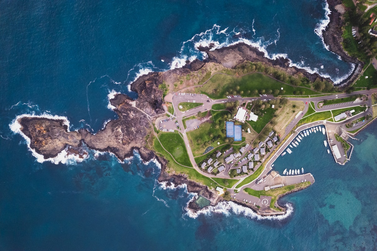 Aerial view of a coastal area with roads and buildings seen from above, showing the kind of perspective used in drone flight planning