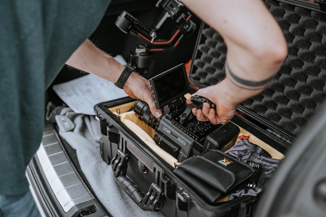 Drone maintenance technician inspecting propulsion system and electronics on a commercial quadcopter in a workshop