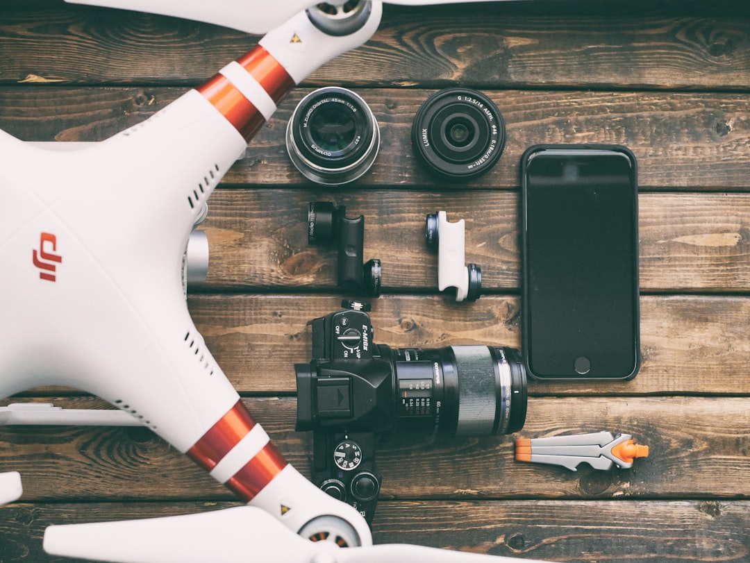 Drone airframe, camera payload, lenses and controller laid out for inspection before entries go into a drone maintenance log