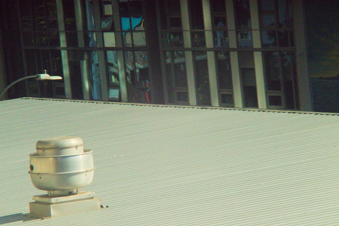 Aerial view of a low-slope commercial metal roof and vent captured during a drone roof inspection for damage assessment and measurement