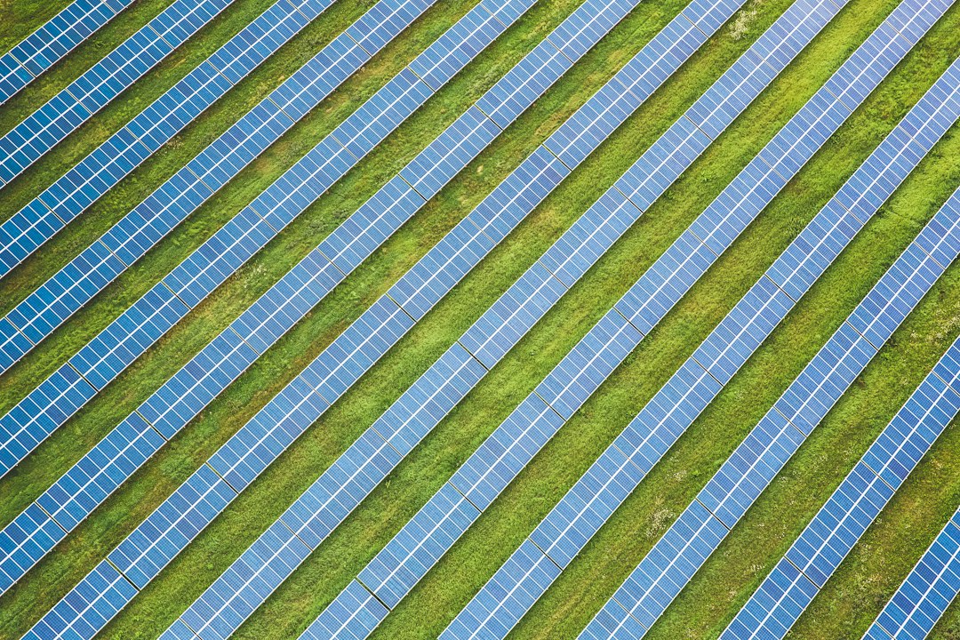 Aerial drone view of rows of solar panels on a solar farm, the kind of energy site teams map and inspect with DroneDeploy alternatives