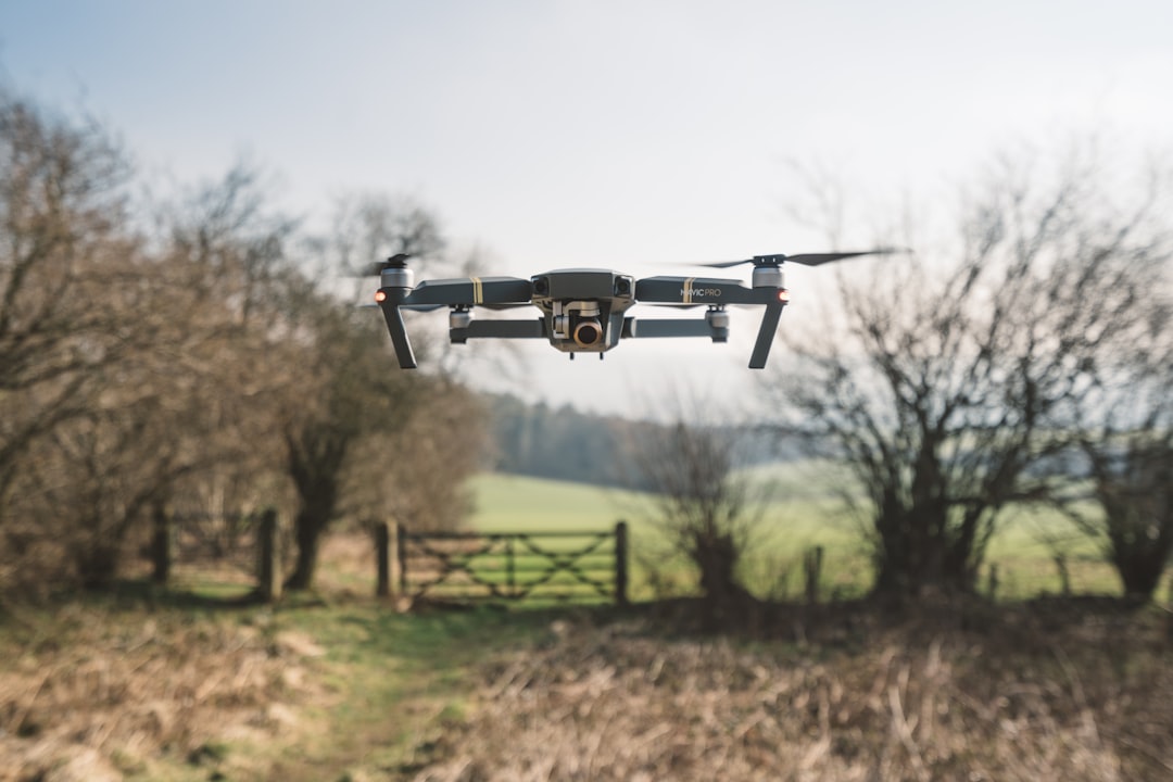Commercial UAV drone in flight over a rural field during an unmanned aircraft system operation